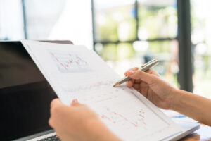 Home - business woman hand with financial charts laptop table