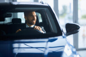 Home - businessman suit buying new car modern salon scaled