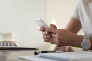 Home - businesswoman looking important contact phone scaled