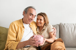 Home - happy european senior couple holding piggybank and 2025 03 18 18 20 04 utc scaled