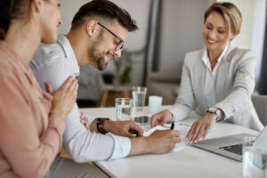 Home - happy man his wife having meeting with financial advisor signing agreement office scaled