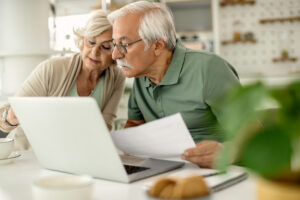 Home - senior couple analyzing their savings while going through home finances 1 scaled