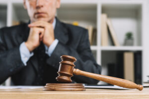 Home - wooden judge gavel table front lawyer scaled